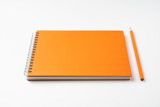 perspective view of spiral orange notebook