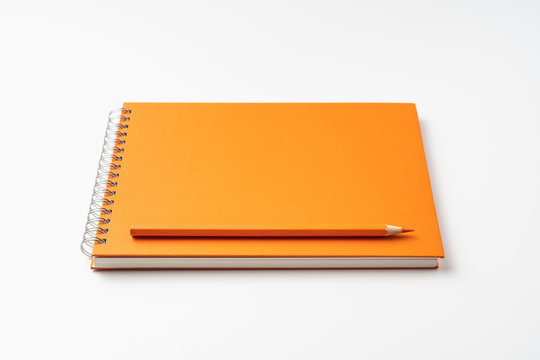 perspective view of spiral orange notebook