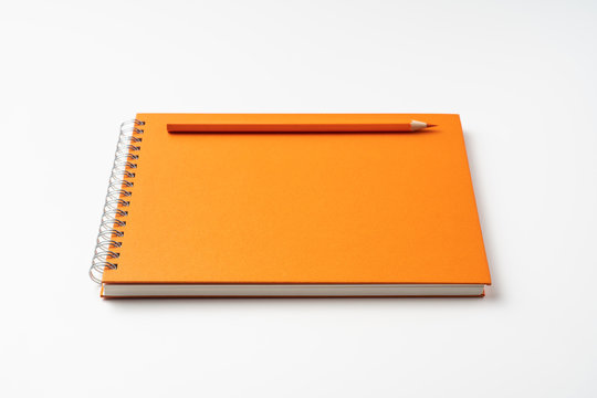 perspective view of spiral orange notebook