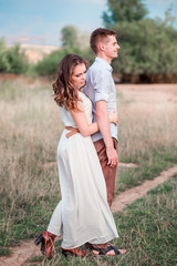 Stylish adult guy and girl hugging. Vertical photo