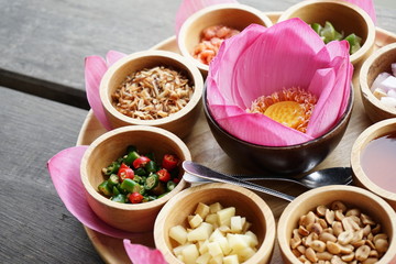 Miang kham old traditional snack in Thailand. Lotus leaf and side dish such as chilil, lemon, small nut wih Sweet sauce.