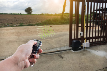 Signal of remote control when person open automatic gate at house for home security system with...