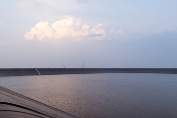 Obraz premium Reservoir and Wind Turbine and Beautiful Sky