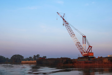 Crawler cranes used for rebuilding bridges  near the river