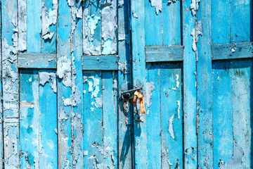 Detail of Old shabby blue wooden door background