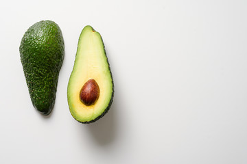 two halves of avocado isolated on white background. copy space