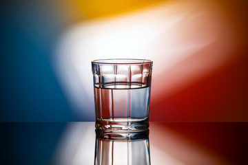 abstract image glass of water on multicolored background
