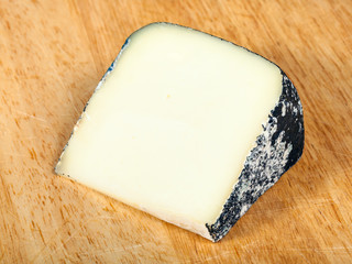 italian Perla Nera sheep cheese on cutting board