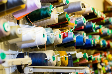 Close Up Of Colorful Sewing Threads In Drawer. Closeup Shot Of Multicolored Spools Of Thread, Sewing Accessories In Atelier.Selective focus.Sewing tools and sewing supplies,accessories