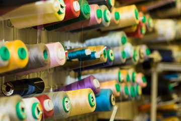 Fototapeta na wymiar Close Up Of Colorful Sewing Threads In Drawer. Closeup Shot Of Multicolored Spools Of Thread, Sewing Accessories In Atelier.Selective focus.Sewing tools and sewing supplies,accessories