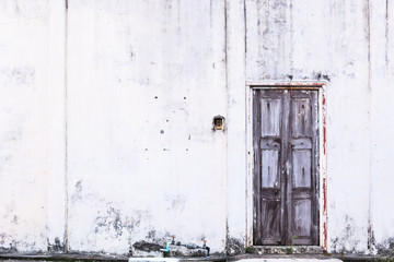 Vintage retro Home interior architectural design, plain old aged tropical brown weathered textured faded wood panel board door and white wall of traditional Asian house. Background or backdrop concept