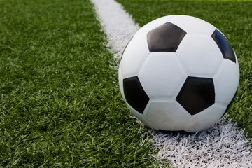 Fototapeta na wymiar soccer ball in the field on the white line