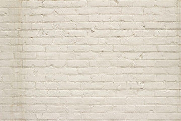 Grungy old white painted brick wall background showing deterioration and stains