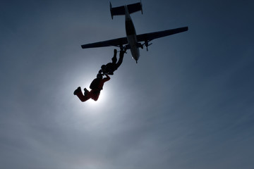 The team of two skydivers is training in the sky.