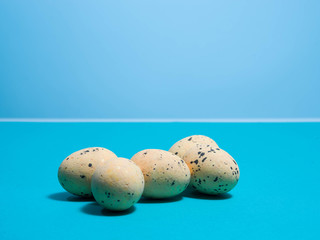 Quail eggs on a blue background