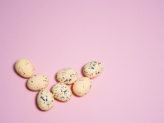 Quail eggs on a pink background.