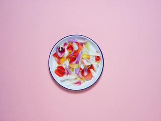 A white plate on a pink background with an Easter decoration.