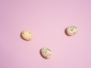 Quail eggs on a pink background.