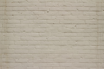 Grungy old white painted brick wall background showing deterioration and stains