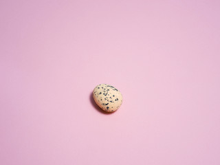 Quail eggs on a pink background.