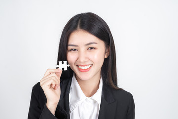 business woman  holding and showing  a jigsaw puzzle - business concept