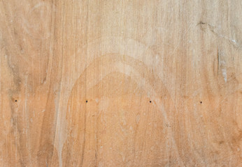 Natural light wooden texture detail of a plank. The surface of brown wood texture,top view brown wood paneling.