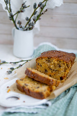 Carrot loaf cake with shiny glaze and nuts on white wooden background close up selective focus
