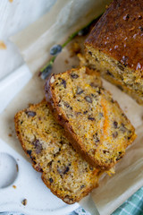 Carrot loaf cake with shiny glaze and nuts on white wooden background close up selective focus