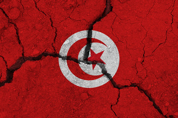 Tunisia flag on the cracked earth