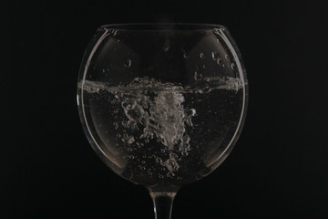 A glass with water at dark background
