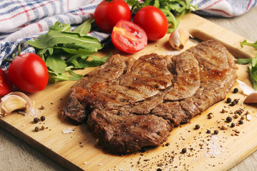 A beef steak well done with vegetables