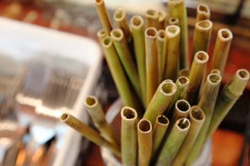 Natural bamboo drinking straw as alternative to plastic one in the cafe with copy space