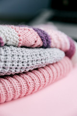 Copy space grey and violet  knitted fabric on a pink background