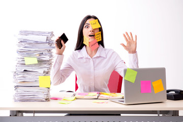 Young female employee in conflicting priorities concept 