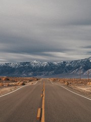 Empty picturesque desert road in the valley of Death, going to the beautiful mountains