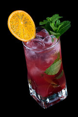 Raspberry Mojito decorated with orange chips. On black background