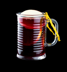 Hot mulled wine with apple. In a glass on a dark background