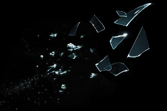 Shattered and splitted glass pieces isolated on black