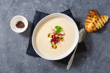 Bowl cheese soup bacon olives top view