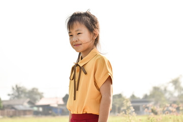 Portrait of smiling cute little girl outdoors in summer day.