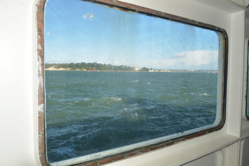 Fototapeta na wymiar View through window of chain ferry across Poole harbour near Sandbanks, Dorset