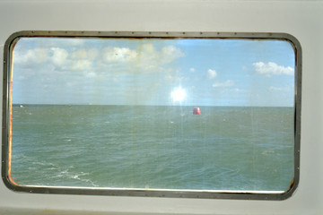 View through window of chain ferry across Poole harbour near Sandbanks, Dorset