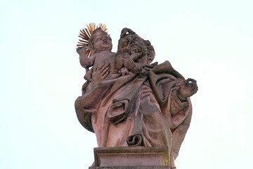 Saint Joseph holding baby Jesus, statue on the portal of Our Lady church in Aschaffenburg, Germany 