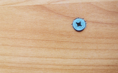 Top view of brown table with flat wood screws and empty space for text.