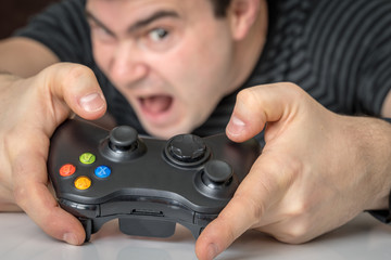 Emotional addicted man playing video games