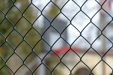 Fototapeta premium Basketball backboard behind steel fence net