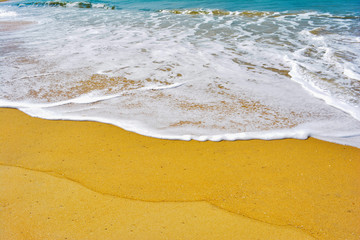 Soft wave lapped the sandy beach