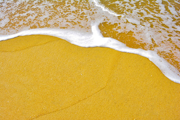 Soft wave lapped the sandy beach