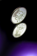 A 50 Fils Coin From The State Of Kuwait And It's Reflection On Purple