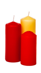 Colored candles of different size on white background